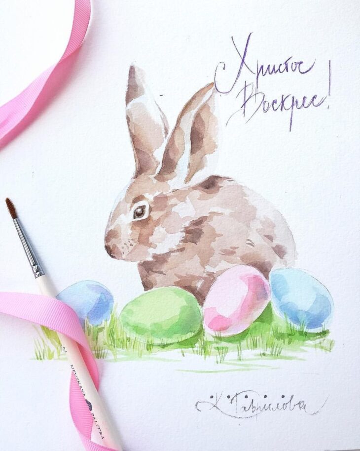 акварельный рисунок кролика с пасхальными яйцами